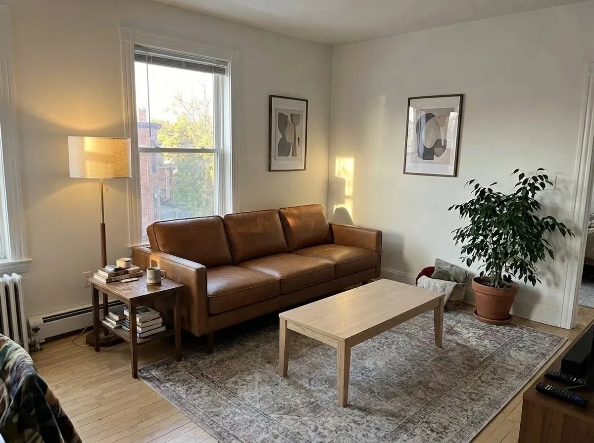 The same room with a new sofa in cognac leather and an oak coffee table